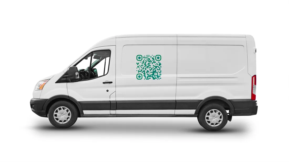 A QR code applied to the side panel of a white delivery van.